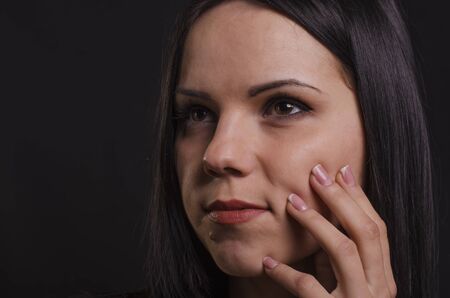 Portrait of a young girl on a black background