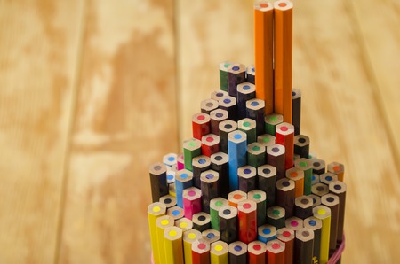 Group of colored wooden pencils close-up on a light backgroundの写真素材