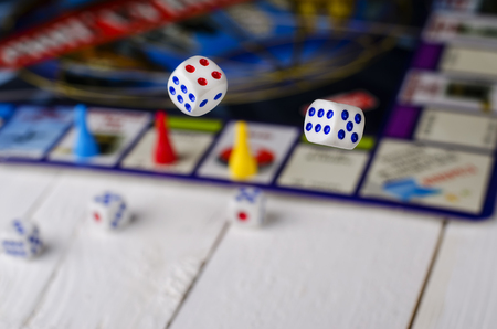 Gambling board game with white cubes on a wooden table