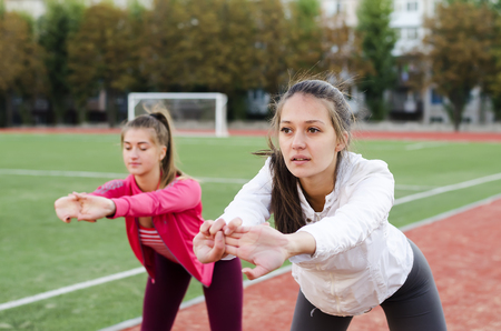 two girls go in for sports in the morning outdoorsの写真素材