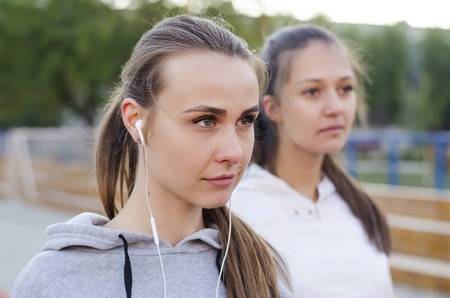 portrait of a girl with headphones outdoors in the morningの写真素材