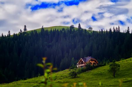 house on a hillside with a beautiful skyの写真素材