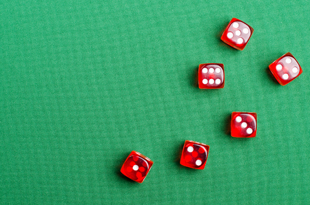 group of red dice on a green casino tableの写真素材