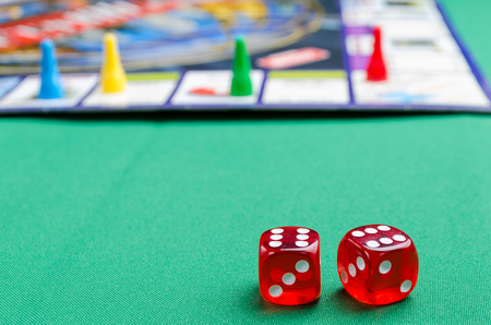 several red dice for board games on a green background