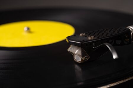 old turntable, black vinyl records, with needle, side viewの写真素材