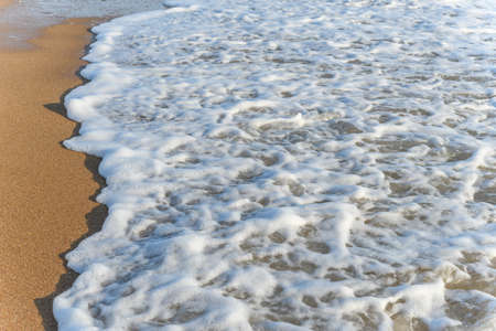 Sea foam on the beautiful sand Atlantic ocean beach.の写真素材