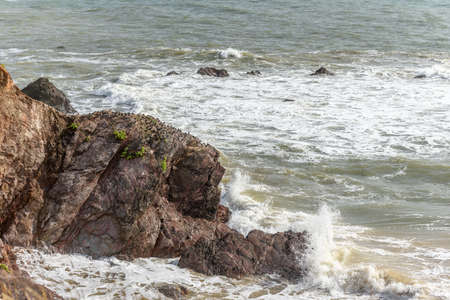 Breaking waves on a rock in the Atlantic Ocean on the French coast.の写真素材