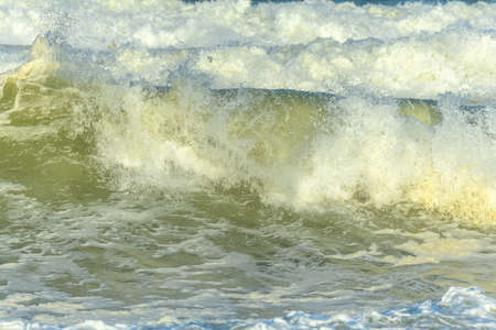 Waves breaking on the beach at the edge of the Atlantic Ocean.