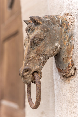 Old rusty horse's head with a ring for tying horses in a backyard. Colmar, Haut-Rhin, European Collectivity of Alsace, Grand Est, France.の写真素材