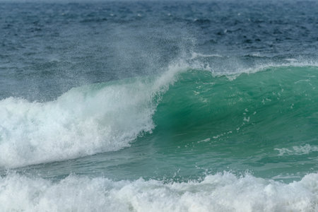 Turquoise blue wave in the Iroise Sea. Camaret, Crozon, Brittany, France, Europe.の写真素材