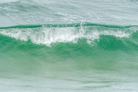Turquoise blue wave in the Iroise Sea. Camaret, Crozon, Brittany, France, Europe.の写真素材