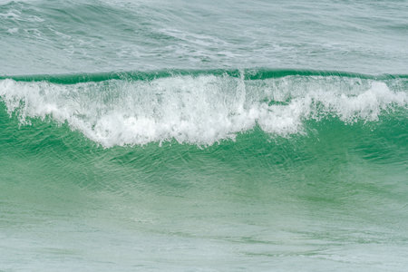 Turquoise blue wave in the Iroise Sea. Camaret, Crozon, Brittany, France, Europe.の写真素材