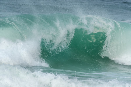 Turquoise blue wave in the Iroise Sea. Camaret, Crozon, Brittany, France, Europe.の写真素材