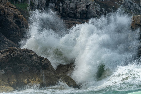 Large waves of the Atlantic Ocean crash against the rocks of a cliff. Camaret sur mer, Crozon,...
