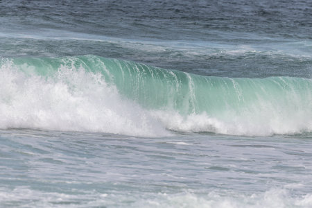 Turquoise blue wave in the Iroise Sea. Camaret, Crozon, Brittany, France, Europe.