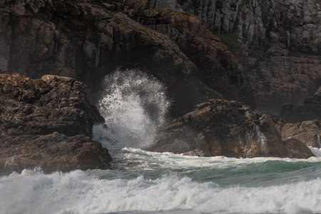 Large waves of the Atlantic Ocean crash against the rocks of a cliff. Camaret sur mer, Crozon,...