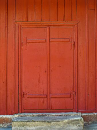 Old red door made of woodの写真素材