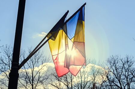 Romanian Flag in the sun, National Day of Romania, blue sky close up.
