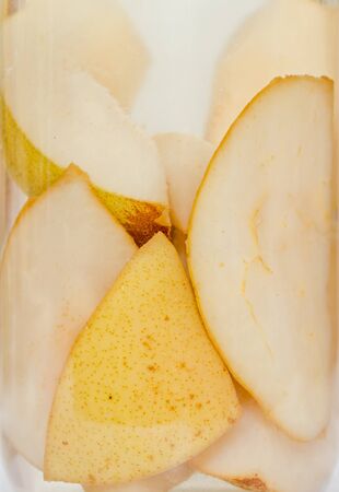 Jar with sliced pears compote, close up.の写真素材