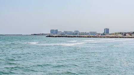 CONSTANTA, ROMANIA - SEPTEMBER 16, 2016: The Black Sea, seafront and seaside with blue water and gold sand, hotels.のeditorial素材