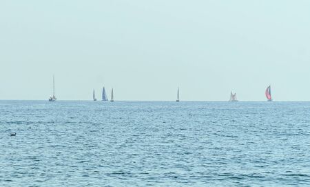 Sailing boats on the Black Sea, blue water waves, clear sky.の写真素材