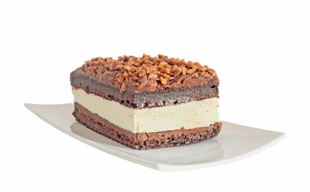 Chocolate cake with hazelnut and white cream, nuts, white plate, isolated on white background, close...