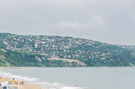 ALBENA, BULGARIA - JUNE 13, 2016. View of the Black Sea shore. green hills with houses, blue sea water, clouds sky. City Balchik coastのeditorial素材