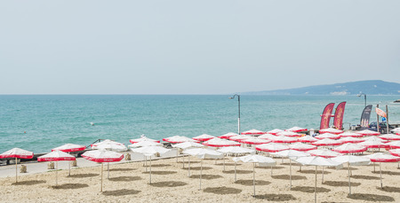 BALCHIK, BULGARIA - JUNE 19, 2016. The Balchik seaside, beach with sands, sun umbrellas and blue water.のeditorial素材