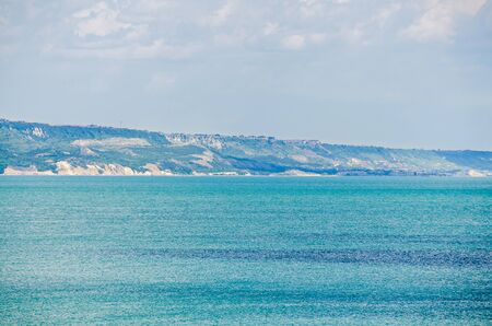 ALBENA, BULGARIA - JUNE 13, 2016. View of the Black Sea shore, green hills, blue clouds sky. City Balchik coast, blue clear sea waterのeditorial素材