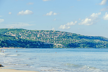ALBENA, BULGARIA - JUNE 13, 2016. The seaside of Black Sea, green hills with houses, blue clouds sky. City Balchik coast, blue clear water.のeditorial素材