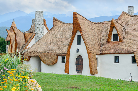 PORUMBACU DE SUS, ROMANIA - AUGUST 10, 2016: Clay Castle, The Valley of the Fairies (Castelul de Lut, Valea Zanelor), Transylvanian Hobbit hotel built out of clay and sand. Grimm houses.のeditorial素材