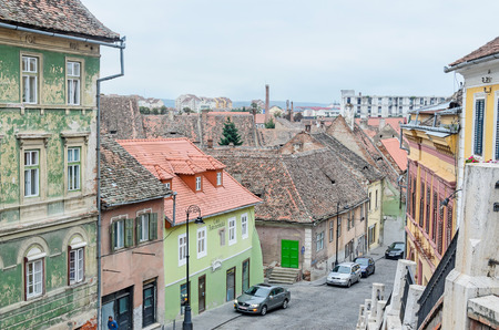 SIBIU, ROMANIA - AUGUST 10, 2016: Streets of the downtown city with restaurants and old buildings, view from Liars Bridgeのeditorial素材