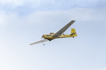 BUCHAREST, ROMANIA - SEPTEMBER 5, 2015. Aerobatic motorplane (sailplane) pilot training in the sky...