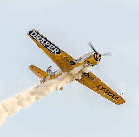 BUCHAREST, ROMANIA - SEPTEMBER 5, 2015. Aerobatic airplane pilots training in the sky of the city. Colored airplane with trace smoke, airbandits, aeroshowのeditorial素材