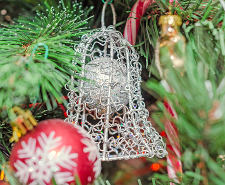 Christmas tree vibrant colored ornaments, globe hanging, snow flake, stars, green tree, firs with cones, close up.の写真素材