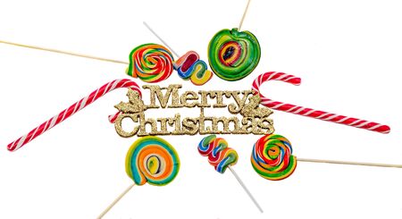 Yellow sparkley Merry Christams write, letters with colored candy sticks and lollipops, isolatedの写真素材