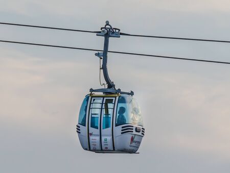 CONSTANTA, ROMANIA - SEPTEMBER 4, 2014: Telecabine called "Telecondola", in the blue sky transporting tourists, sunset timeのeditorial素材