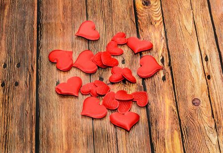 Textile red hearts, Valentines Day hearts, brown wood background.の写真素材