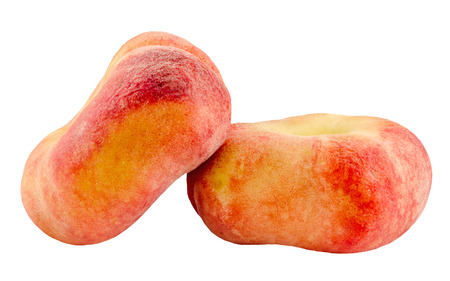 Saturn peaches, also known as Donut (Doughnut) peaches, are a variety of peach with white flesh and a flattish, round shape. Close up.の写真素材