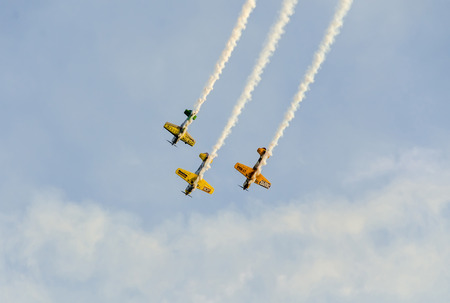 BUCHAREST, ROMANIA - SEPTEMBER 5, 2015. Aerobatic pilots training in the blue sky, airplanes with colored trace smoke.のeditorial素材