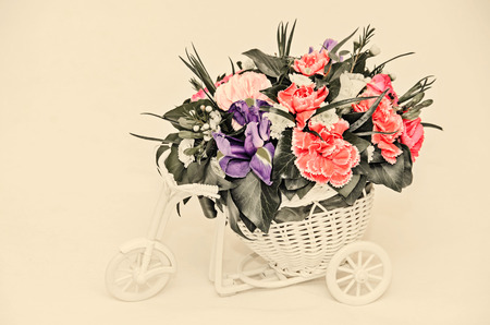 Floral arrangement with white bicycle and colored flowers roses, iris, chrysanthemums, Carnations, vintage style.の写真素材
