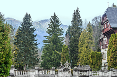 ROMANIA, SINAIA - APRIL 4, 2017: Detail from garden of the Peles Castle from Sinaia Romania, green treesのeditorial素材