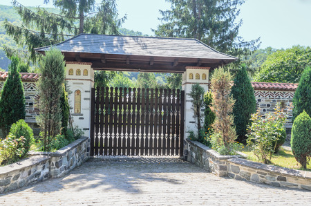 VALEA JIULUI, ROMANIA - AUGUST 1, 2017: The old Lainici Monastery on a summer's day, detail of entrance gate.のeditorial素材