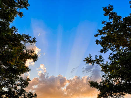 Spectacular blue sky with mistic clouds and rays of lightsの写真素材