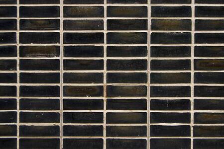 black rectangular tiles wall, repetitive pattern