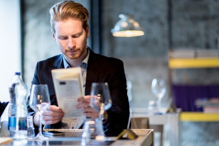 Businessman deciding on what to order in a restaurant