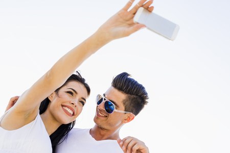 Beautiful  young couple taking a self portrait on a summer dayの写真素材