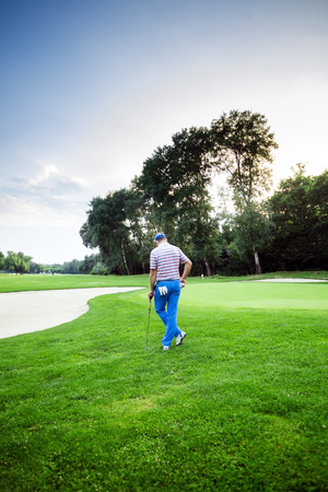 beautiful scenery with a golfer, course, sunset landscapeの写真素材