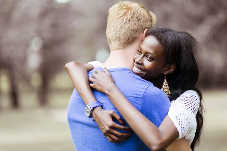 Couple in love hugging peacfully outdoors and being truly happy. Feeling of security and serenityの写真素材