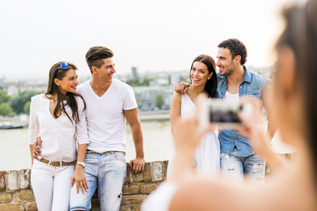 Young and beautiful couples taking photos with smartphoneの写真素材